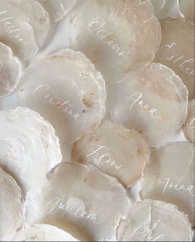 Translucent white jars or containers labeled with handwritten month names from a calendar or planner arrangement